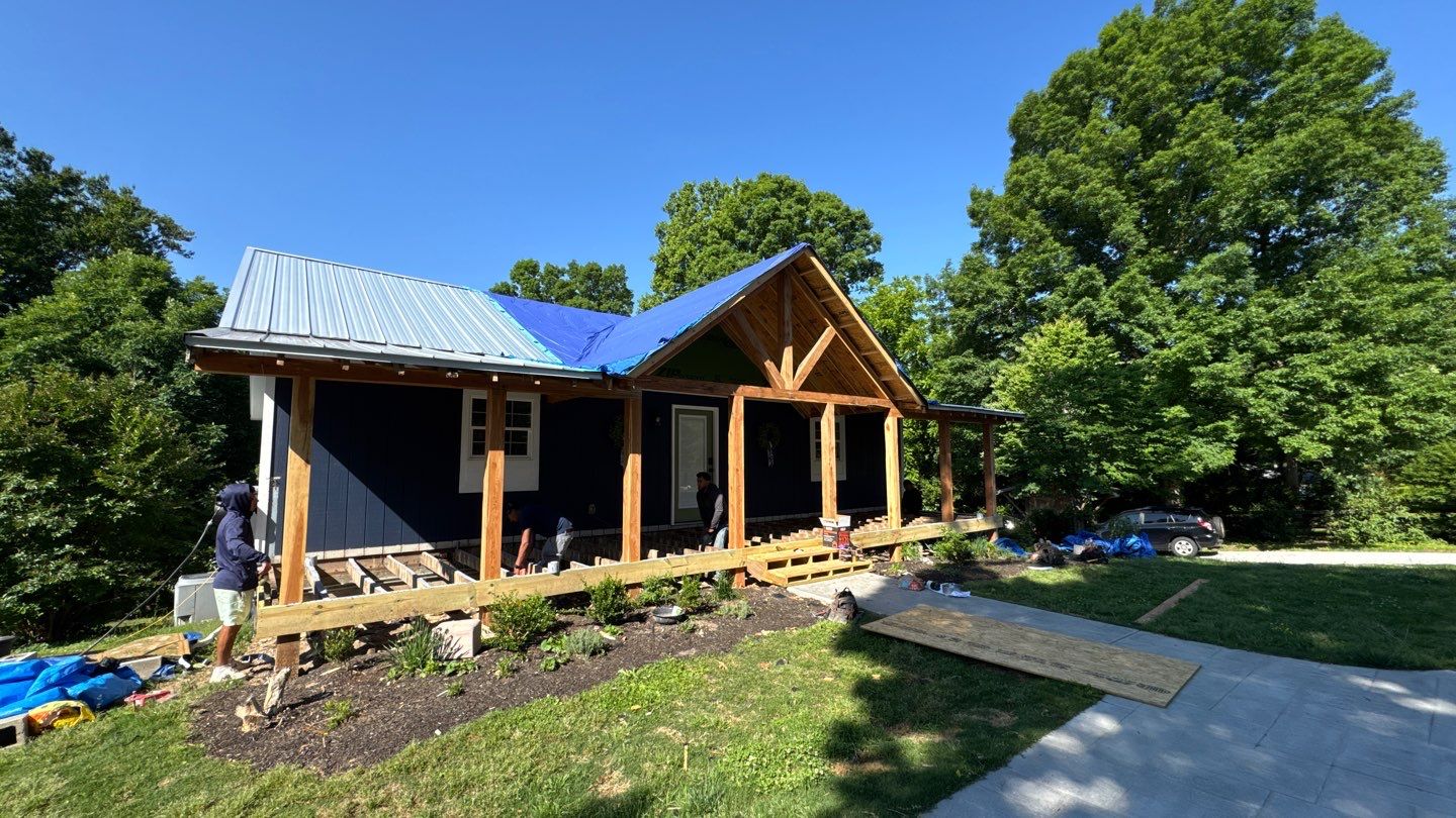 Home 3 Standing-seam metal roof being installed during a porch and exterior renovation.