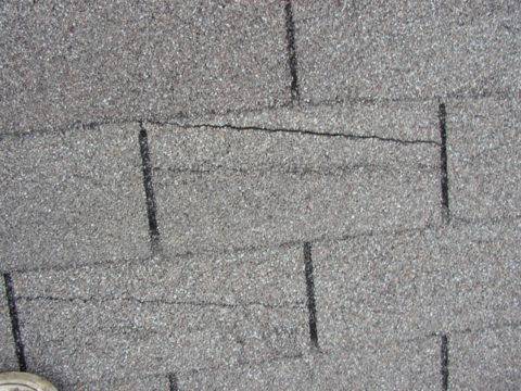 Home 7 Roof shingles marked during an inspection to document storm damage.